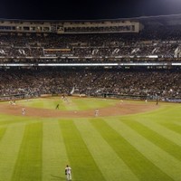 A Pittsburgh Pirates fan waves a Jolly Roger flag as she sits with hundreds  of others as they gather outside PNC Park in Pittsburgh on Thursday, Oct.  3, 2012, to watch a