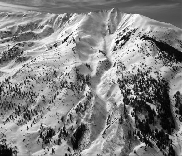 Backcountry skiers track up Mt Daly, Snowmass, Colorado (Black and White)